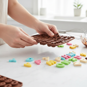 Hands removing chocolate letter